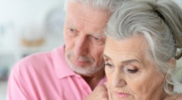 Older adult practicing mindfulness meditation in a peaceful setting, promoting emotional healing and well-being in later life.