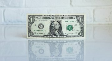 A concerned individual reviewing medical bills and insurance papers after a personal injury accident, seeking clarity on healthcare costs and compensation.