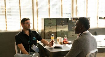 A diverse group of people engaging in community service activities such as volunteering, mentoring, and helping others, symbolizing the power of kindness and making a positive impact in people’s lives.