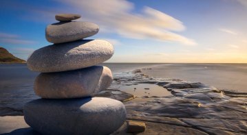 Person journaling with sunlight streaming in, symbolizing a positive and uplifting mindset