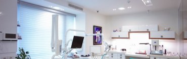 A comprehensive guidebook, dental tools, and a smiling patient in a dental clinic, representing tips for choosing the right dental care services.