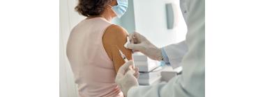 Elderly patient receiving pneumonia vaccine from a healthcare professional as part of preventive senior care