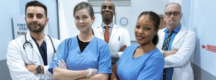 Confident nurse leader in uniform addressing a diverse medical team in a hospital meeting room, symbolizing the skills, dedication, and leadership required in nursing.