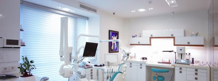 A comprehensive guidebook, dental tools, and a smiling patient in a dental clinic, representing tips for choosing the right dental care services.